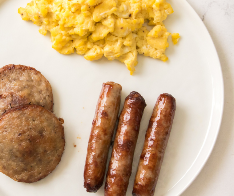 Tasty Air Fryer Johnsonville Breakfast Sausage links topped with a sprinkle of herbs.