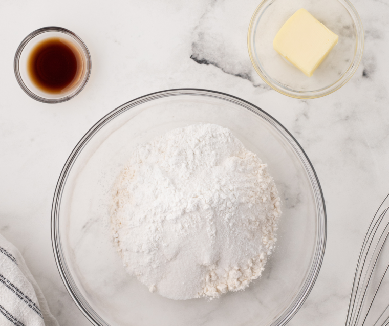 Whisking dry ingredients and mixing wet ingredients together in bowls to prepare pancake batter for air fryer pancake cereal.