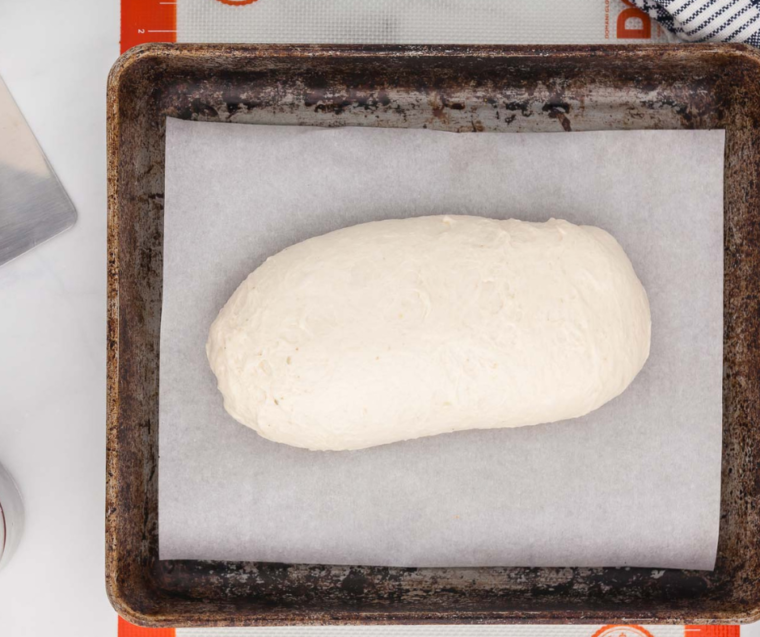 Shaped sourdough bread loaf on parchment paper ready for the air fryer