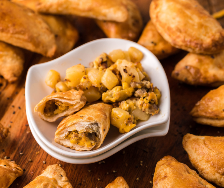 Golden brown Air Fryer Breakfast Empanadas arranged on a serving platter.