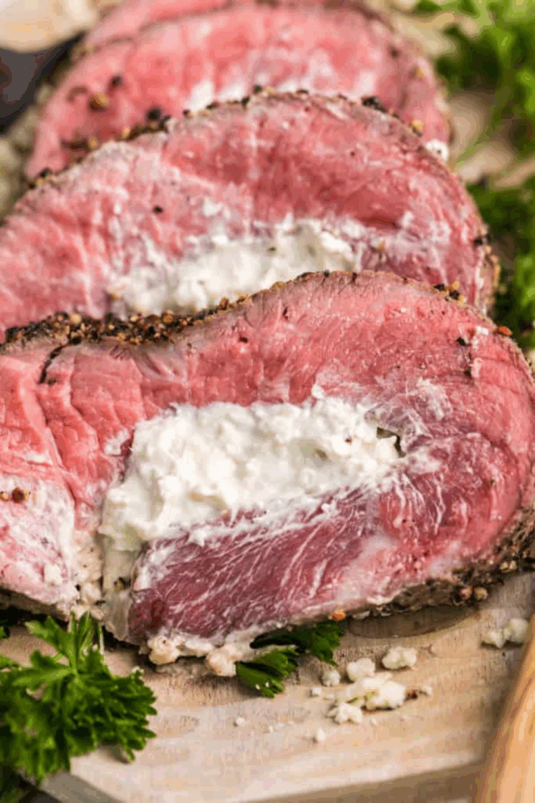 Air fryer blue cheese stuffed flank steak sliced and served on plate