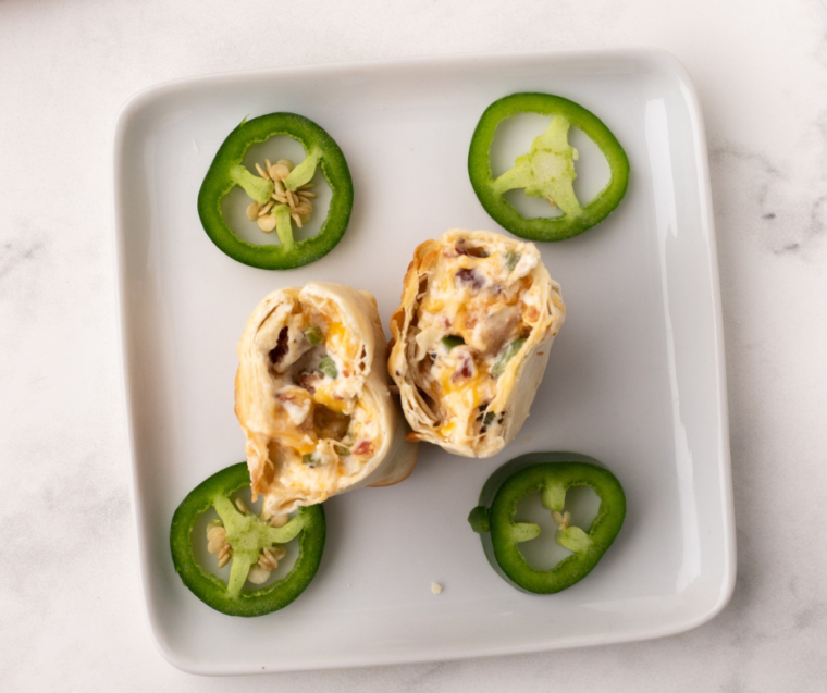Golden and crispy Air Fryer Jalapeno Popper Egg Rolls filled with creamy cheese and spicy jalapenos, served as a perfect appetizer.