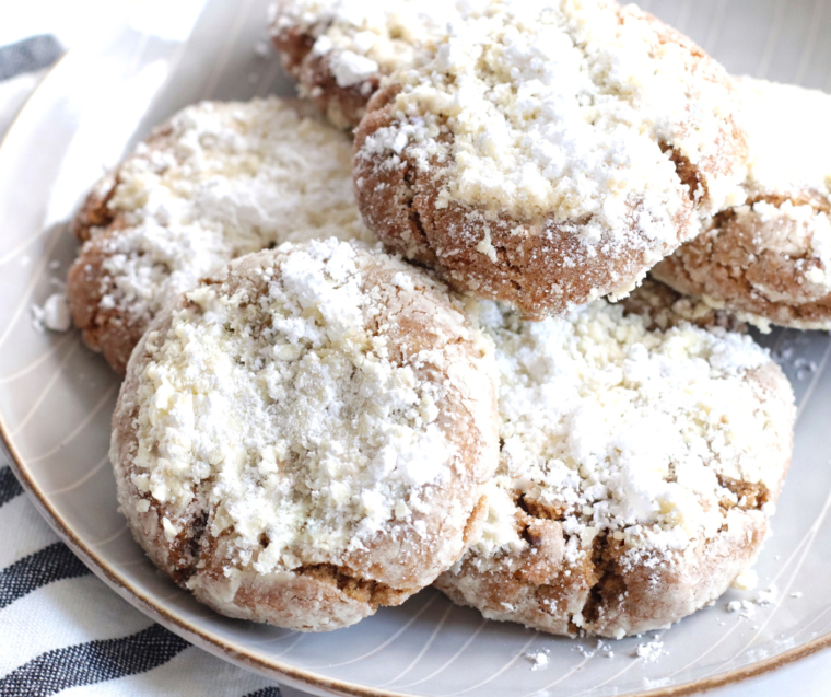 Air Fryer Gingerbread Crinkle Cookies with cracked powdered sugar tops on a plate.