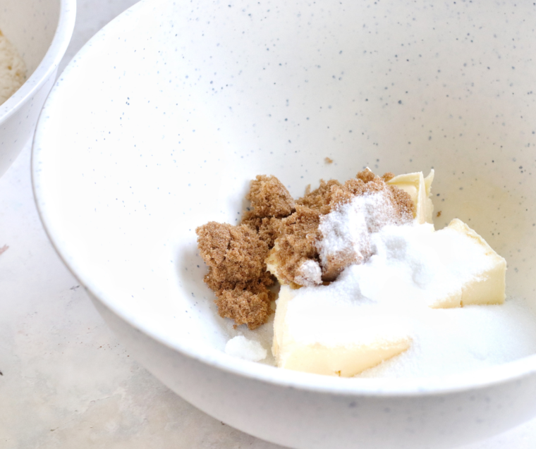 Mixing butter brown sugar vanilla egg yolk and molasses in a large bowl with a hand mixer.