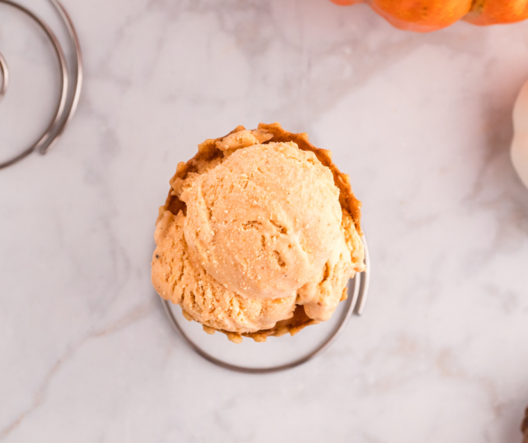 Scoops of low-carb keto pumpkin ice cream served in a white bowl