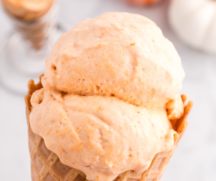 Keto pumpkin ice cream scooped into a bowl with a spoon