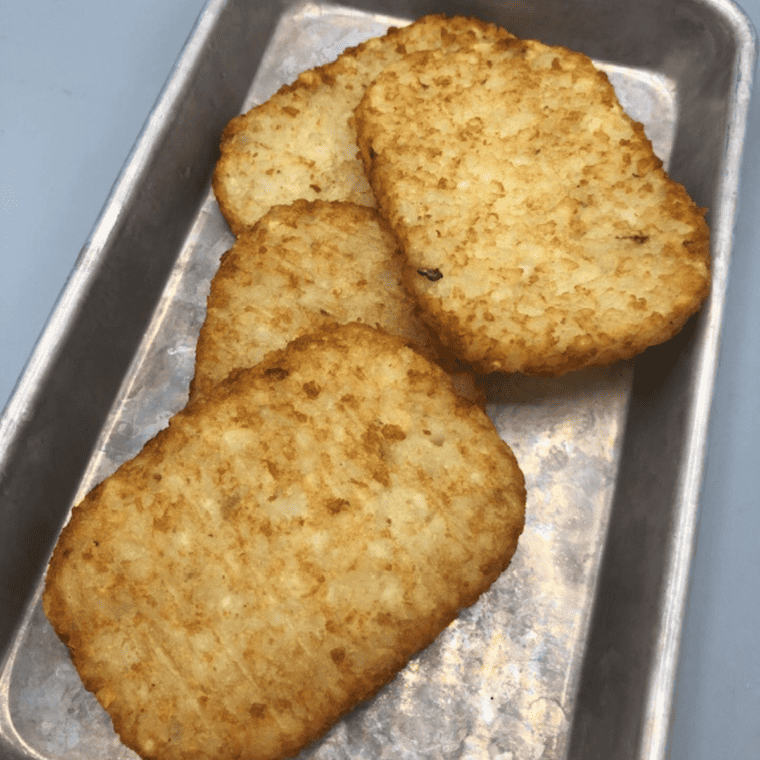 overhead closeup: trader joe's hash browns air fryer recipe on a metal dish