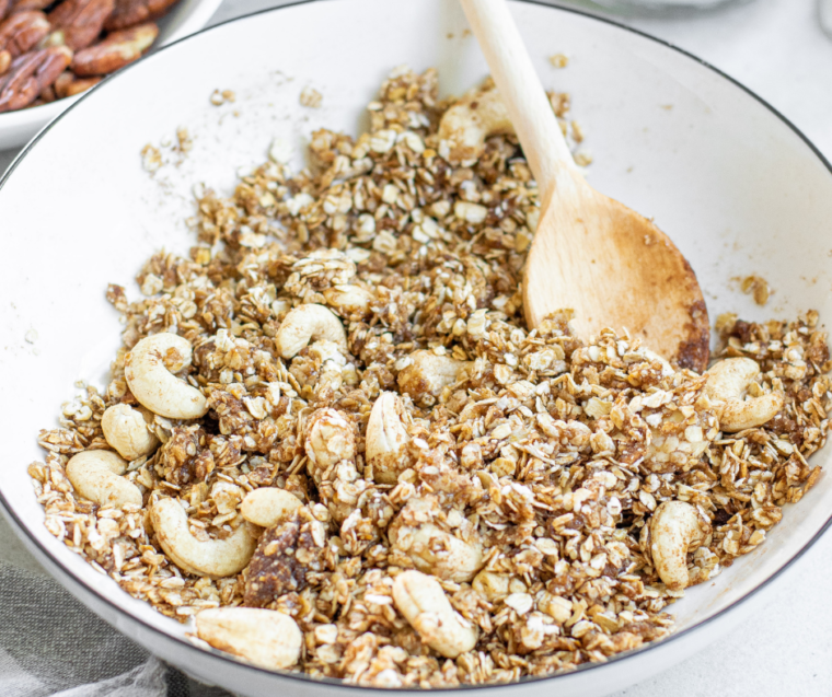 Muesli ingredients tossed together in a large mixing bowl before toasting