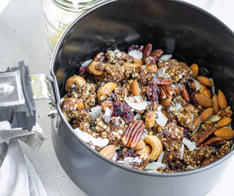 Stirring air fryer muesli halfway through cooking for even toasting