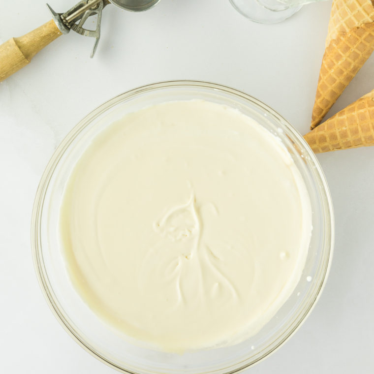 Mixing heavy cream, whole milk, sugar, and vanilla extract until smooth.