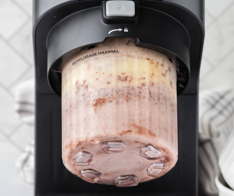 Place the frozen container into the Ninja Creami machine and select the 'Ice Cream' function