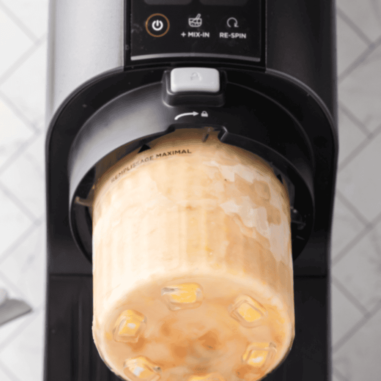 After freezing, break the mixture into chunks and place in the Ninja Creami bowl. Process until smooth and creamy.