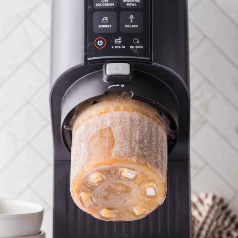 Remove frozen pint from freezer, insert into Ninja Creami, and process using 'Lite Ice Cream' mode.