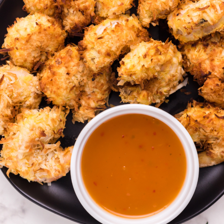 "Plate of crispy Air Fryer Kirkland Panko Shrimp served with a side of dipping sauce."