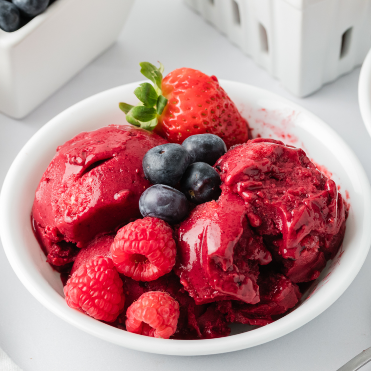 Delicious Ninja Creami Mixed Berry Sorbet served in a bowl, garnished with fresh berries on top.