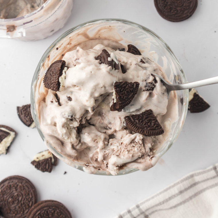 Creamy Cookies and Cream Protein Ice Cream made in a Ninja Creami, topped with crushed Oreo pieces in a white bowl.