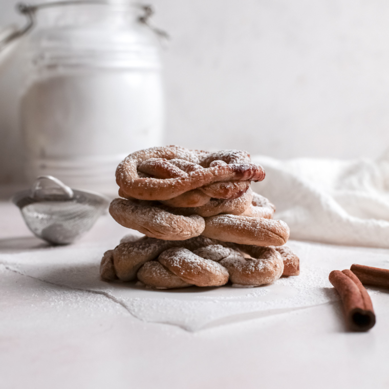 Ingredients needed for reheating funnel cakes in the air fryer, including funnel cakes and optional toppings like powdered sugar and fruit