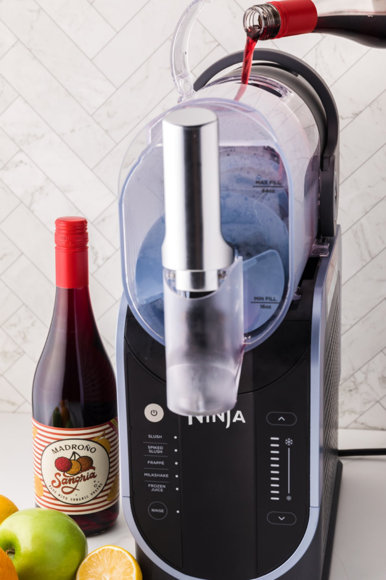 Pouring Sangria Wine into the container.