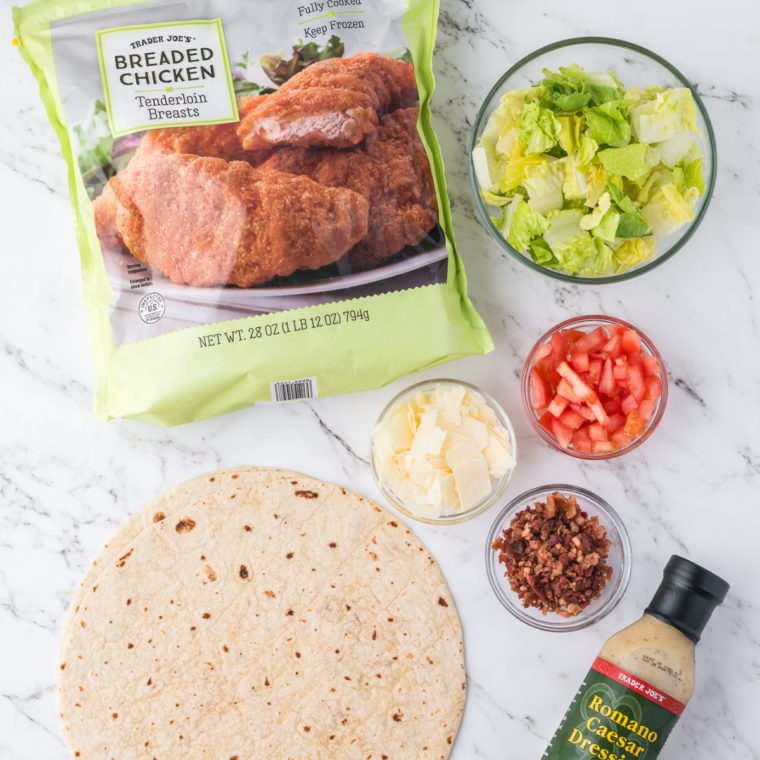 Ingredients for air fryer chicken Caesar wraps: frozen chicken tenders, romaine, Caesar dressing, Parmesan, tortillas, bacon bits