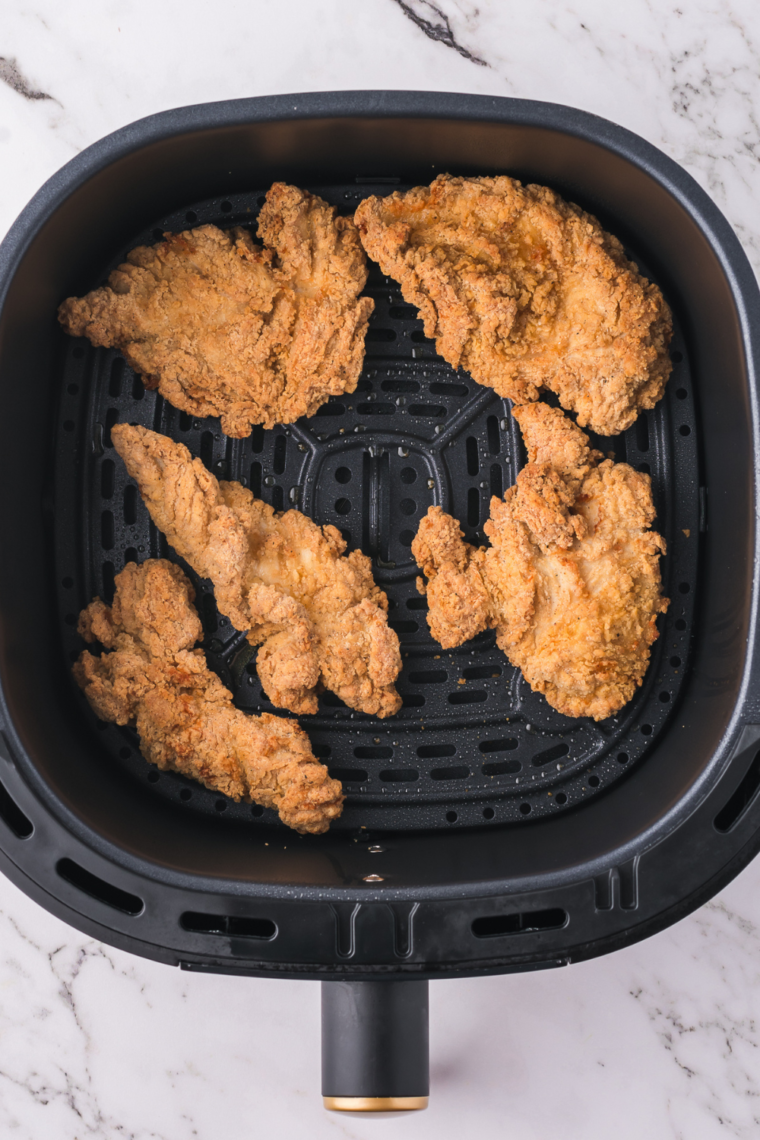 Crispy air-fried chicken tenders sliced into strips for Caesar wraps