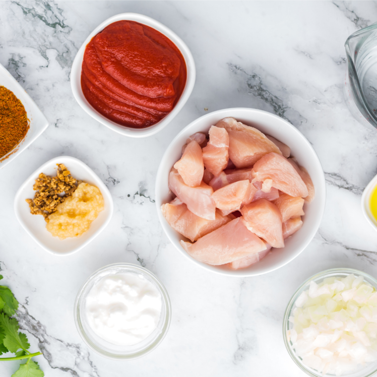 Ingredients needed for Air Fryer Chicken Vindaloo on kitchen counter. 