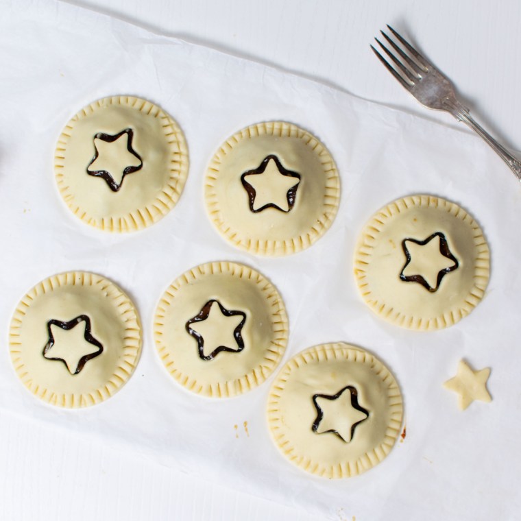 Sealing the edges of the mincemeat pies before air frying.