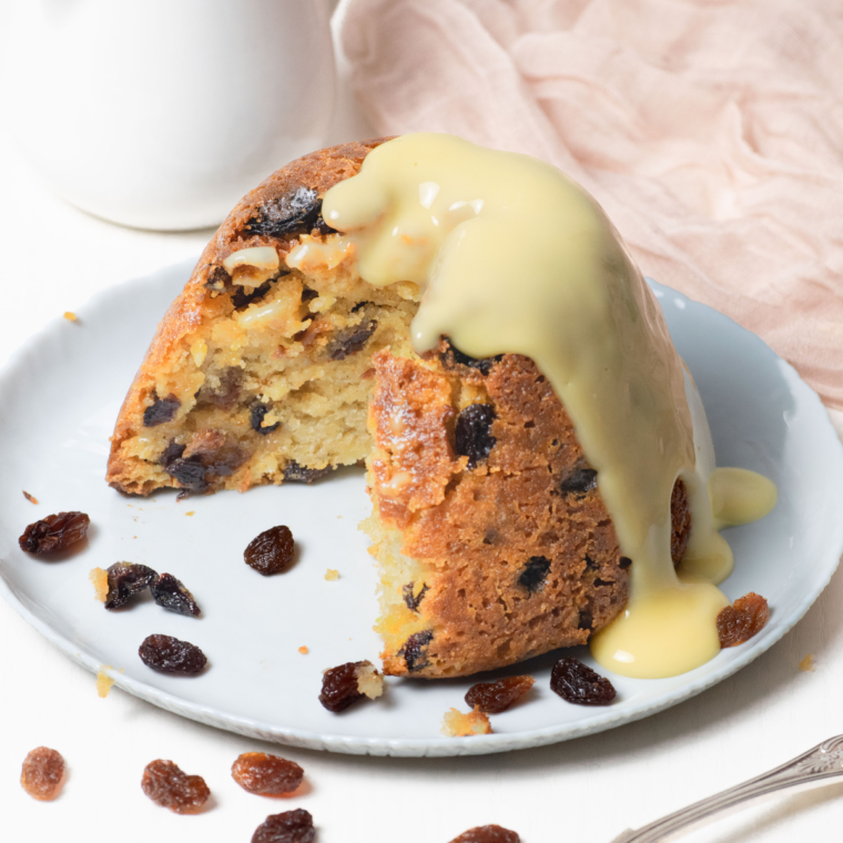 Close-up of Air Fryer Spotted Dick pudding with a golden crust and currants.