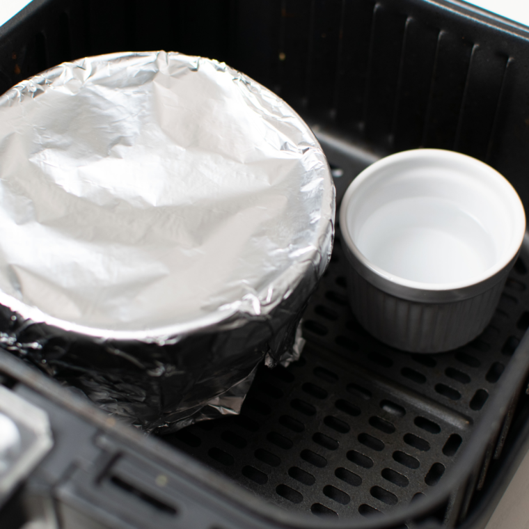 Wrapping the Spotted Dick dough in parchment for air frying.