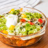 "Air Fryer Taco Fiesta Bubble Up Casserole with golden-brown bubbly biscuit pieces topped with melted cheese and fresh cilantro."