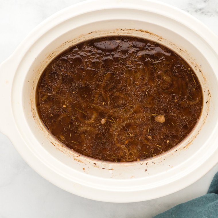 Transfer the sautéed onions and garlic to the slow cooker. Add the beef broth, soy sauce, Worcestershire sauce, balsamic vinegar, and brown sugar. Stir to combine.