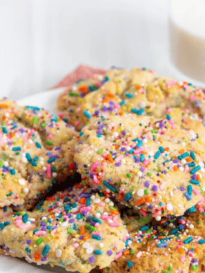Copycat Publix sugar cookies topped with rainbow nonpareils on a wire cooling rack