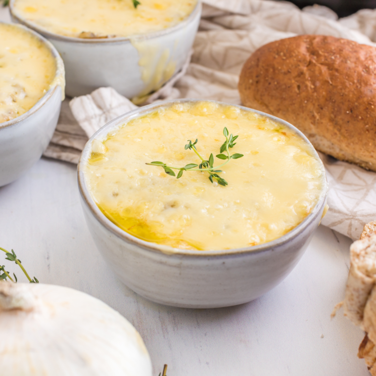 Homemade copycat Longhorn French onion soup with golden, bubbly cheese over a crusty bread slice