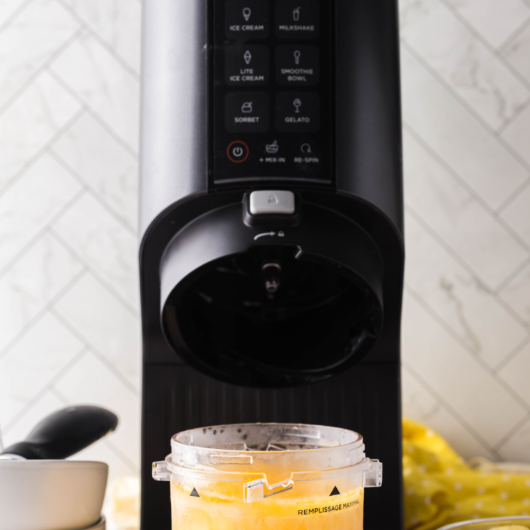 Blending sorbet mixture in Ninja Creami machine for smooth consistency