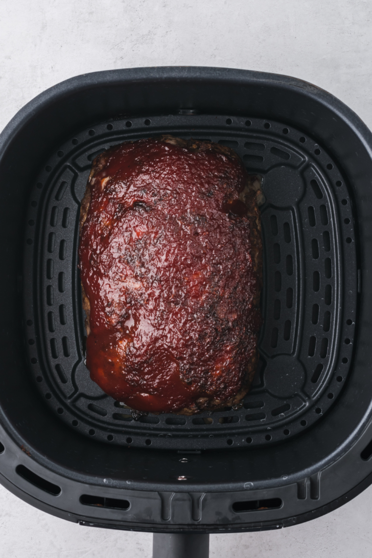 Close-up of Outback Steakhouse Spicy Jammin' Meatloaf served with sides."
