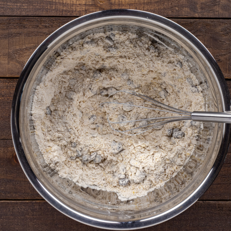 Step-by-step process of making Publix Breakfast Bread, mixing dry ingredients, folding in fruit and nuts, and preparing the loaf pan.