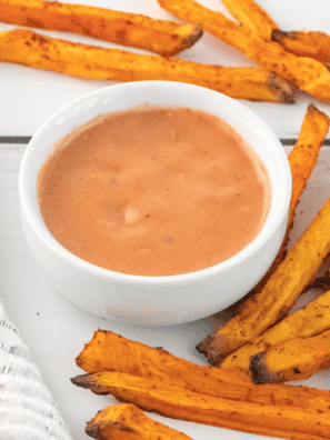 A bowl of homemade A&W Spicy Chipotle Dipping Sauce with a side of crispy fries for dipping.