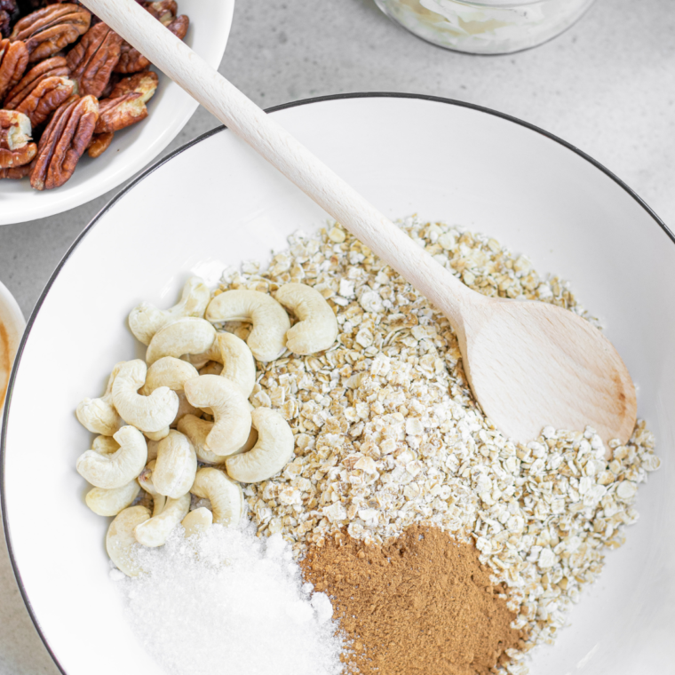 Stirring nut butter and honey into protein granola mixture before air frying.