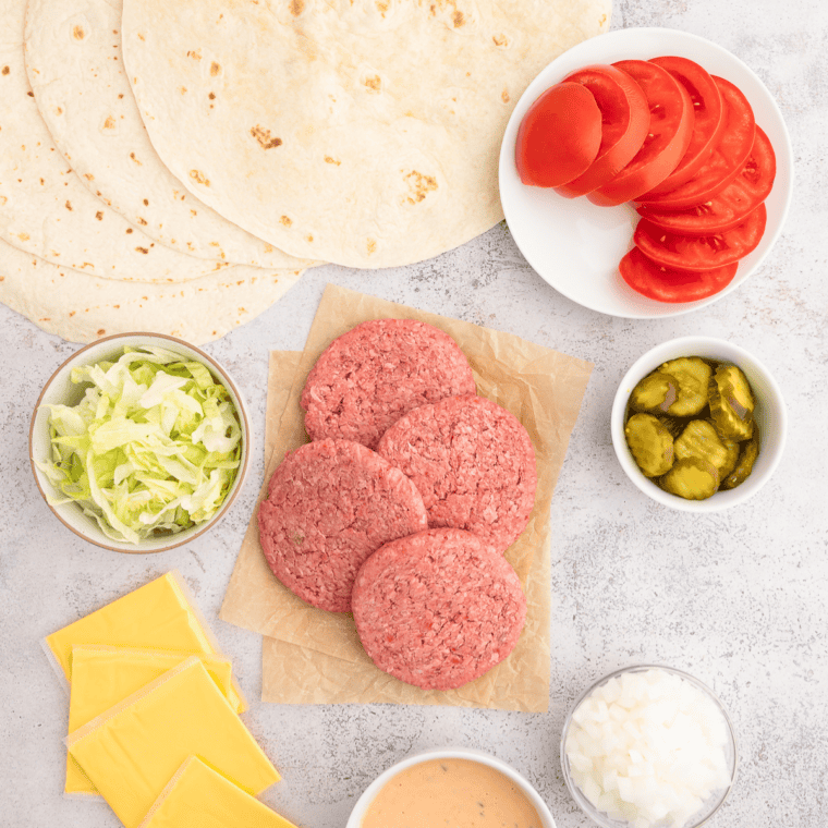Ingredients needed for Copycat In And Out Burger Wrap on kitchen table.