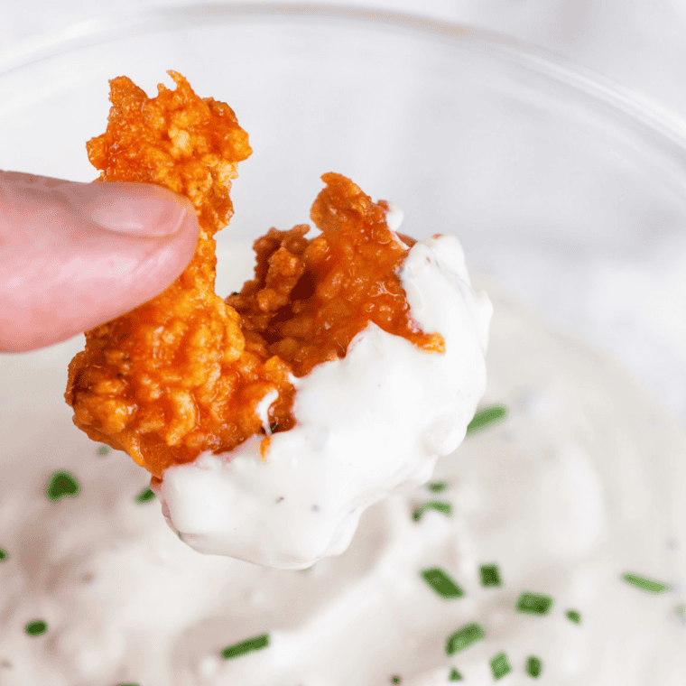 Homemade Texas Roadhouse Blue Cheese Dressing served in a bowl, with chunks of blue cheese, ideal for salads and dipping.