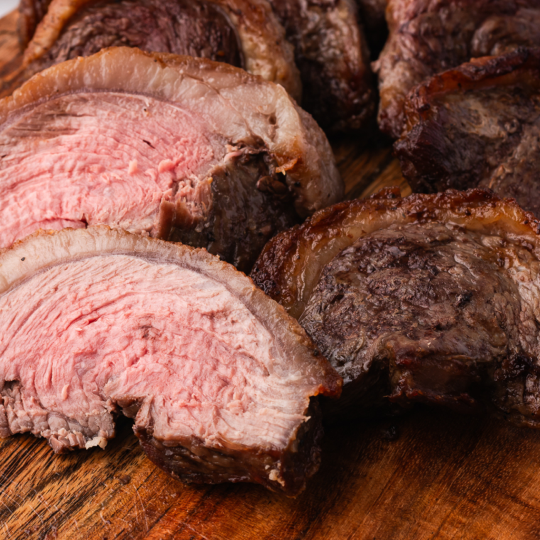Copycat Fogo de Chão Picanha steak cooked to perfection, sliced and served on a wooden board.