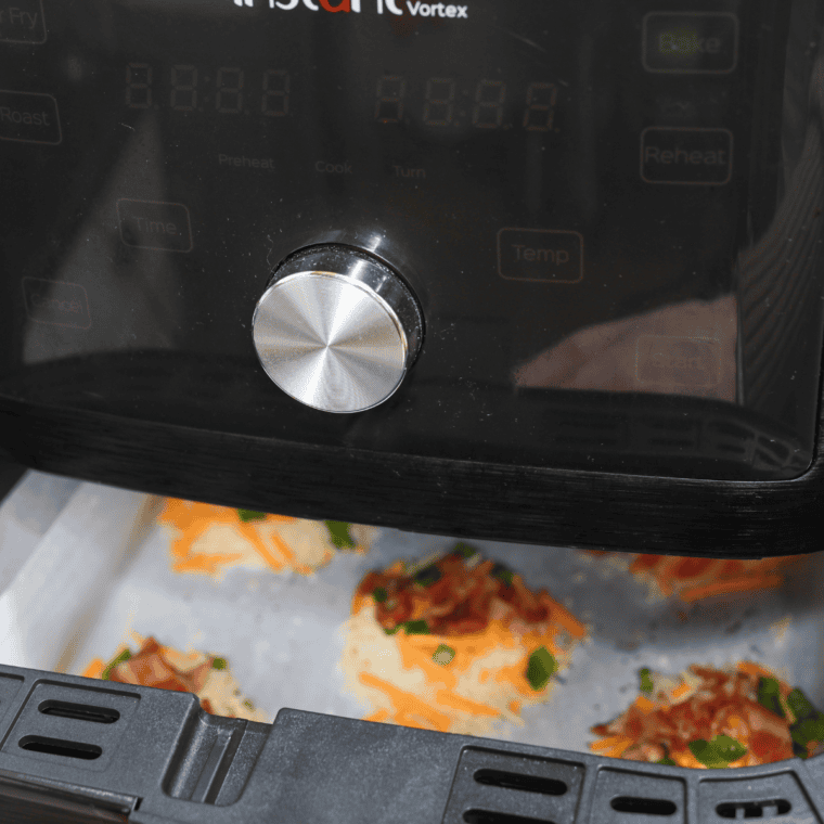 Jalapeño popper crisps cooking in the air fryer at 350°F until golden and bubbly.