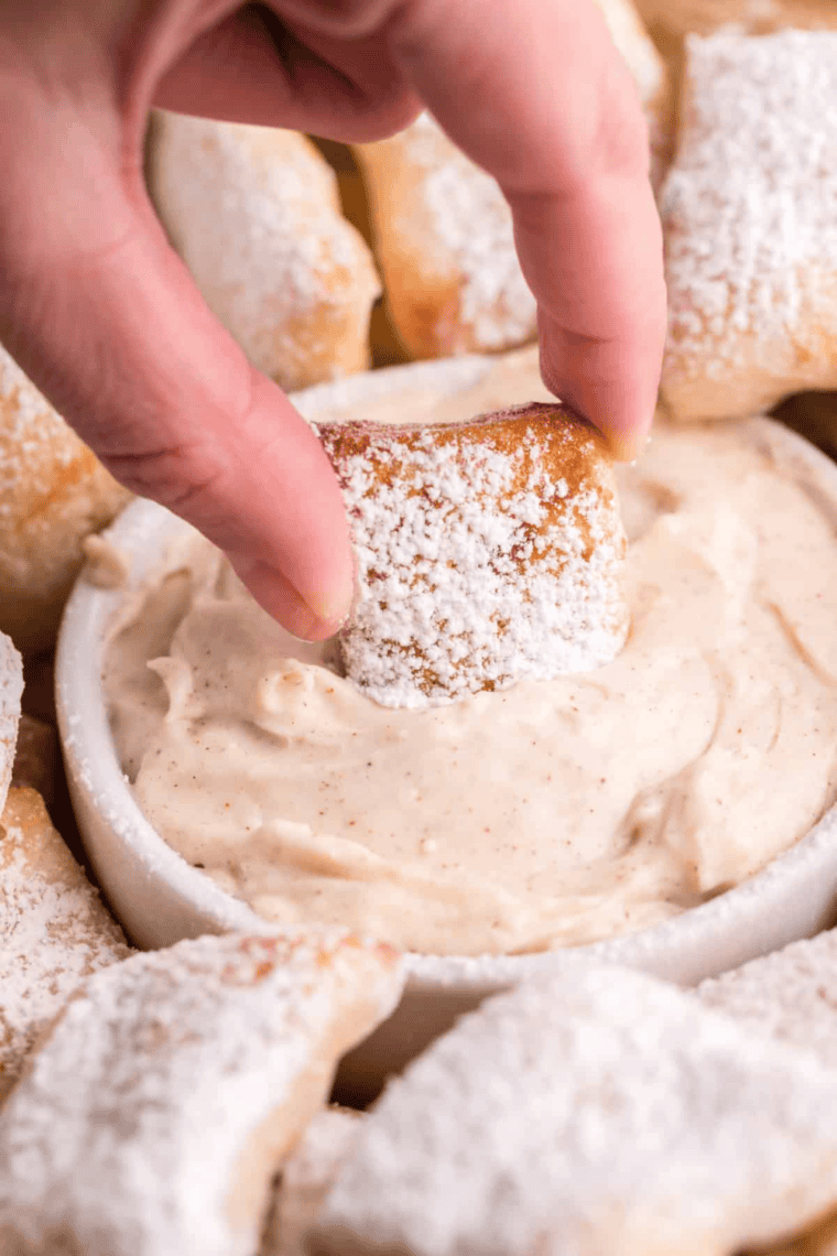 Domino's Garlic Parmesan Sauce in a small bowl with a creamy texture and a sprinkle of Parmesan cheese.
