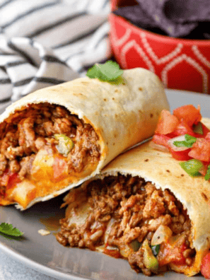 Golden crispy Air Fryer Beef Chimichangas filled with tender beef and melted cheese, served with a side of salsa.