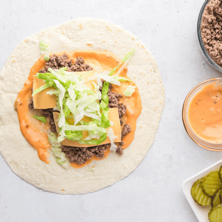 Tortillas spread with Thousand Island dressing, filled with beef, cheese, lettuce, onions, and pickles.