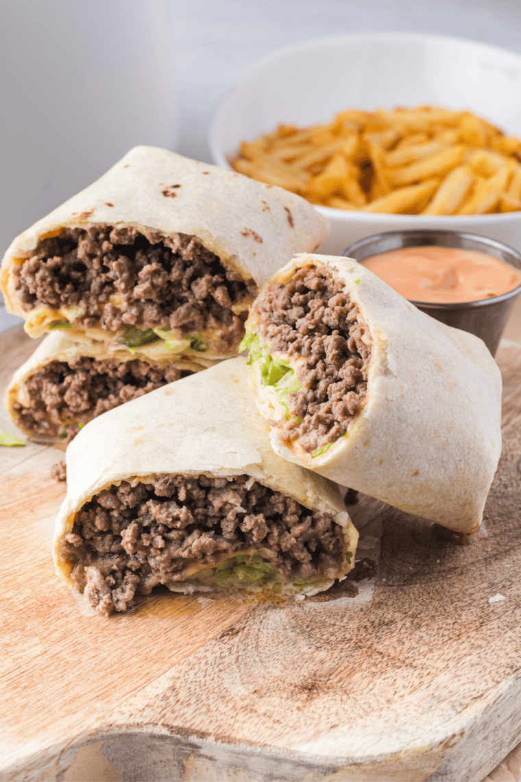 Air Fryer Big Mac Wraps with beef, cheese, and fresh toppings in crispy tortillas, served with dipping sauce.