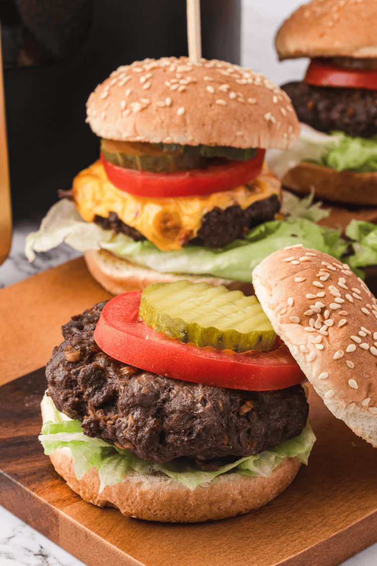 Delicious Air Fryer Lipton Onion Soup Mix Burgers cooking in the air fryer basket, perfectly golden and juicy.