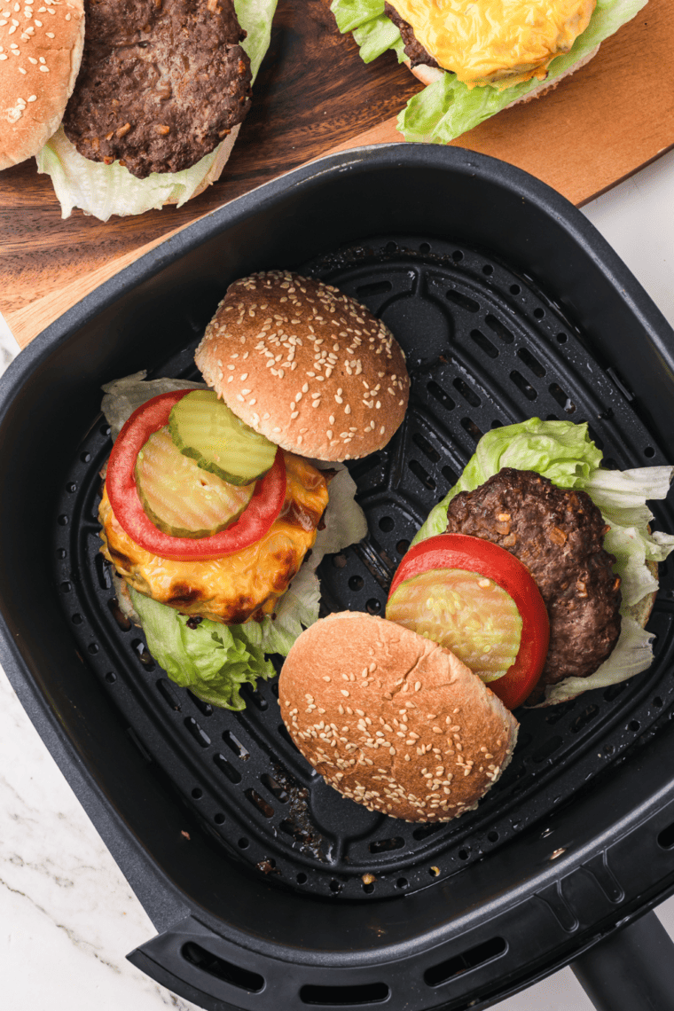 Air fryer Lipton onion soup mix burger patty cooking in the air fryer basket.