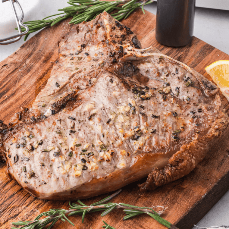 Juicy Bistecca Alla Fiorentina steak served with lemon wedges, perfectly air fried to golden-brown perfection.