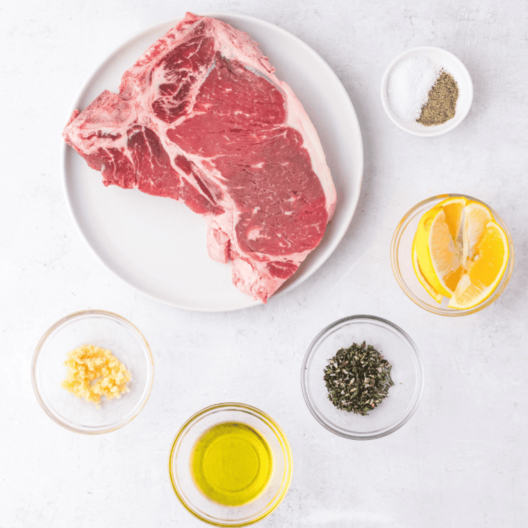 Ingredients needed for Bistecca Alla Fiorentina Recipe (Florentine Steak) on kitchen table.