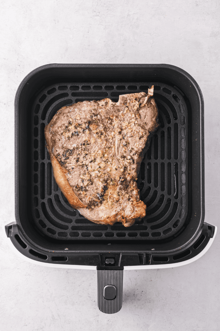 Freshly cooked steak resting on a cutting board to retain its juices before slicing and serving.